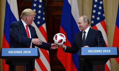 Putin tặng Trump quả bóng trong hội nghị ở Phần Lan ngày 16/7. Ảnh: AFP.